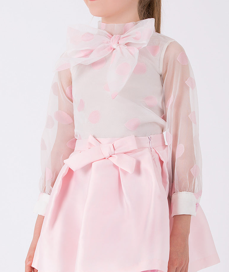 a pink polka dots blouse with a bow and simple elegant pink skirt