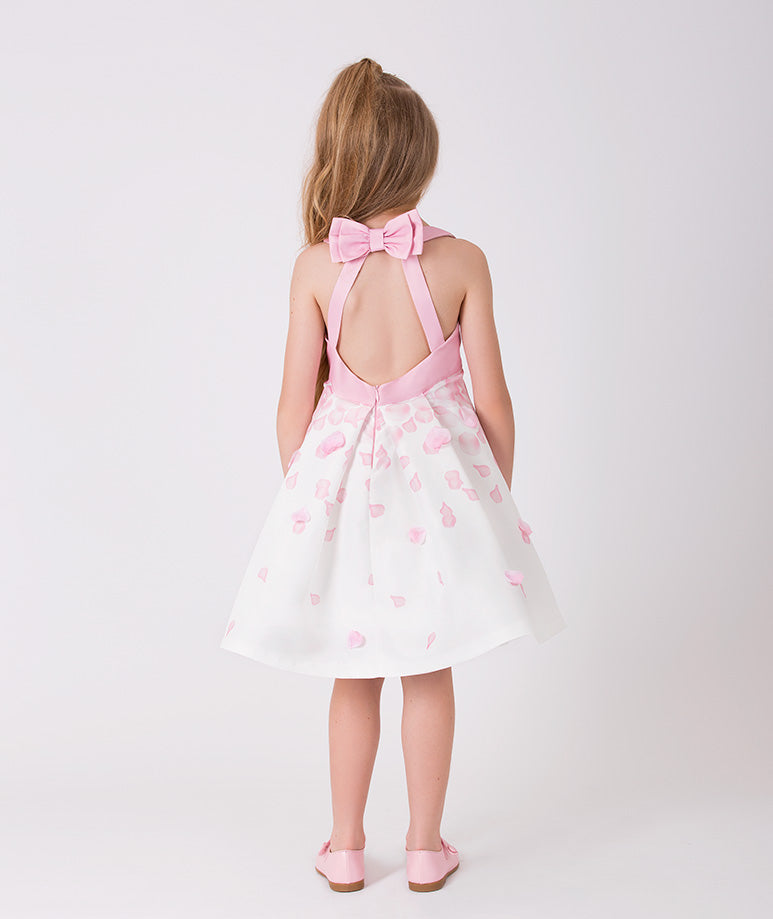ecru dress with a pink top, an open back with a cute little bow on it and rose petal prints