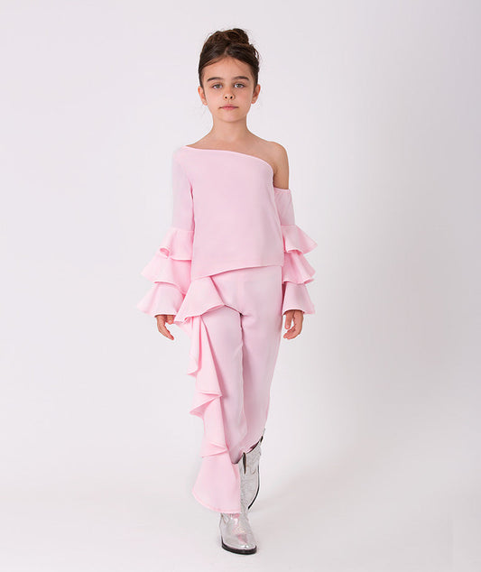 A playful set of a pink ruffled blouse that has a low-cut shoulder and matching ruffled sweatpants