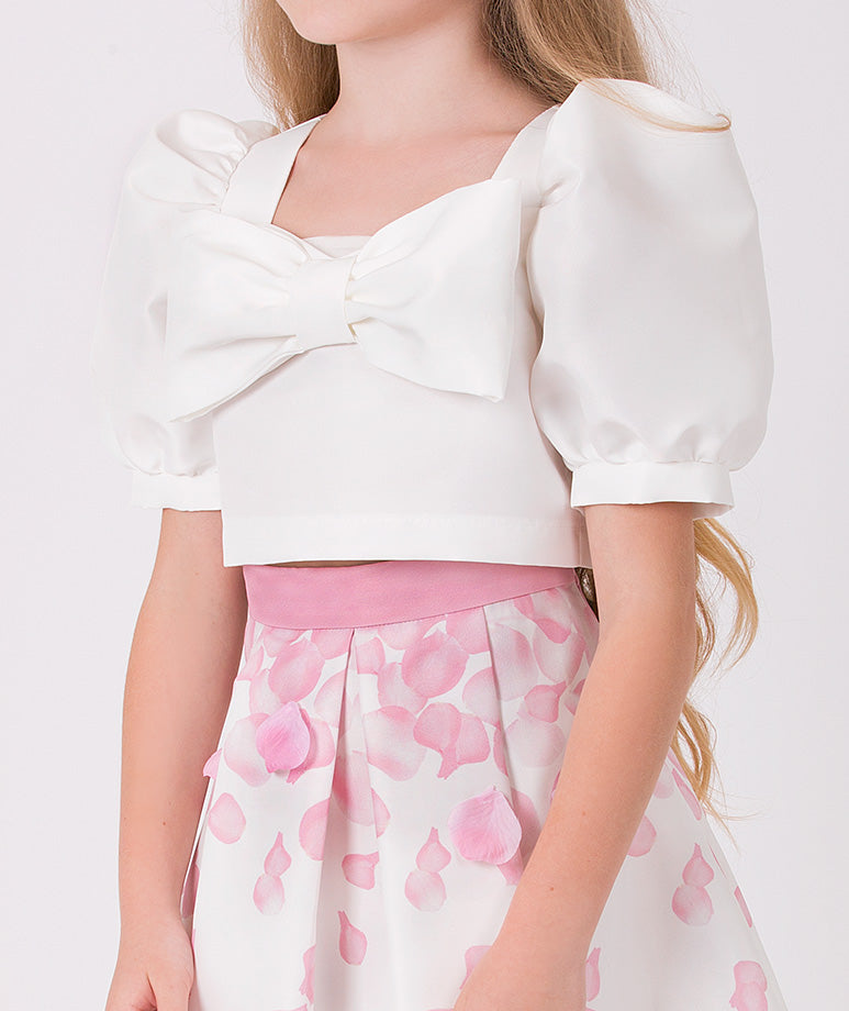 ecru blouse with balloon sleeves and a cute bow with a matching skirt that has pink 3D rose petals